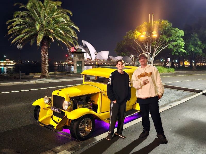 Mates celebrating an 18th birthday with the hot rod and Sydney Harbour Bridge in the background, great birthday gift ideas