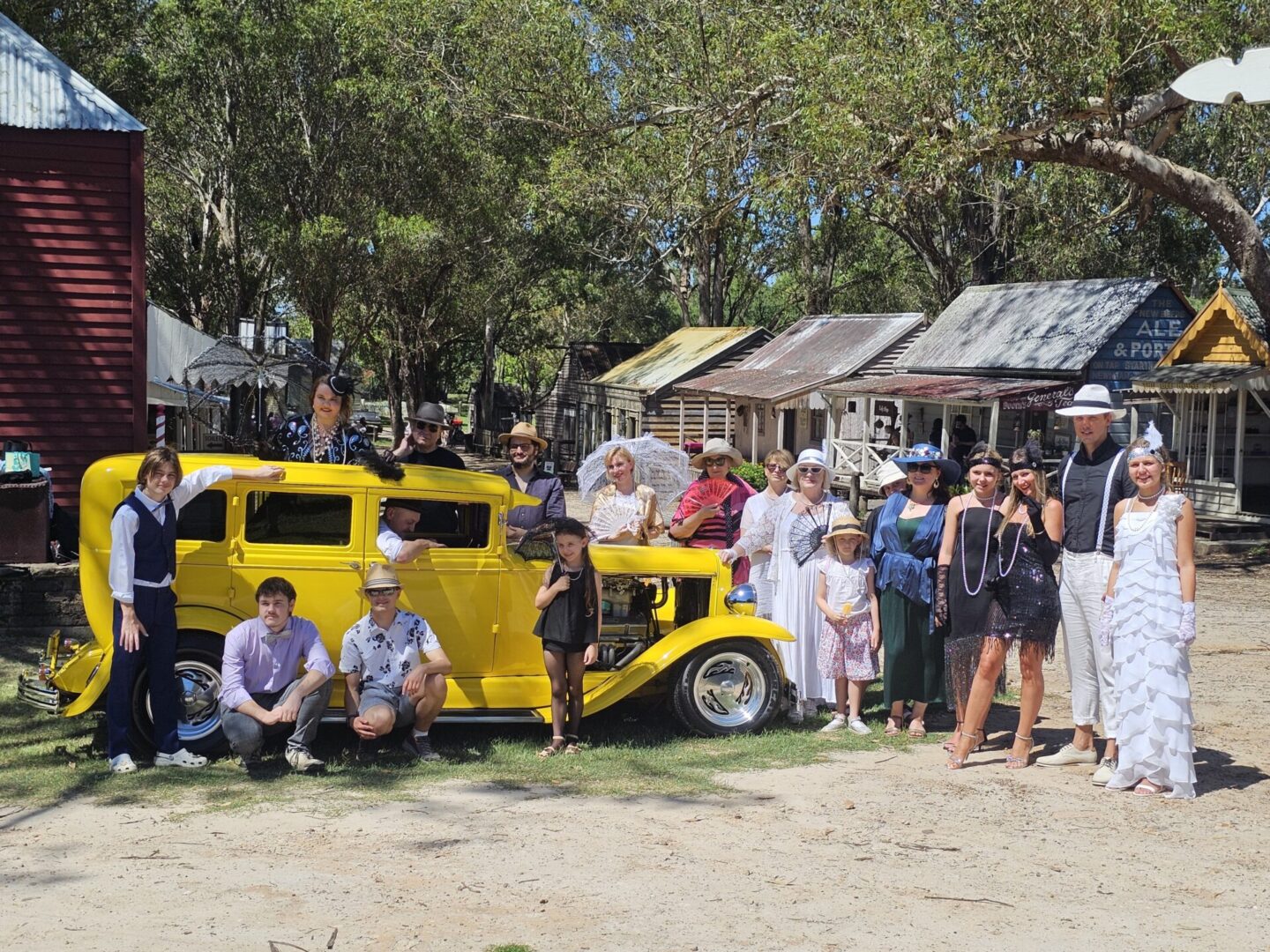 Dressed up in 1920s-style outfits for a family photo shoot with the yellow hot rod, making memories together